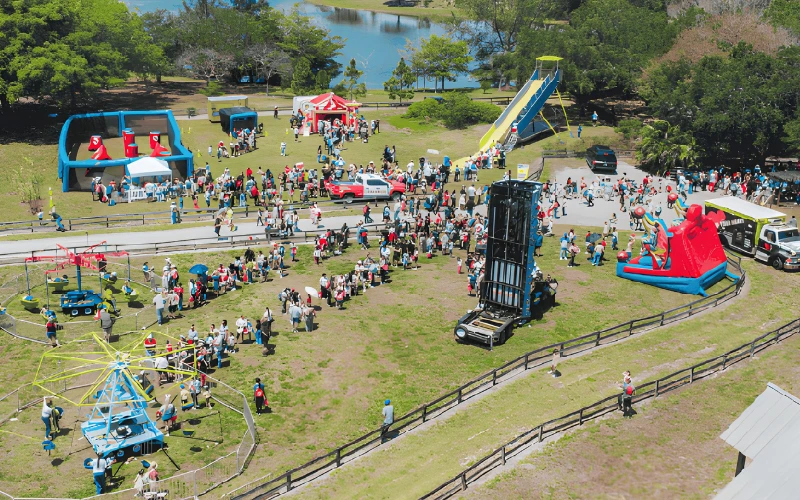 Community event with gellyball, inflatables, and carnival rides